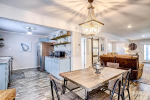 a kitchen and living room with a table and a dining room at Pura Vida - 2 Houses - Murrells Inlet in Myrtle Beach