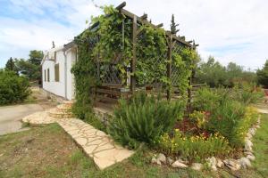 a garden with a pergola covered in vines at Holiday house with a parking space Rudina, Hvar - 18333 in Stari Grad