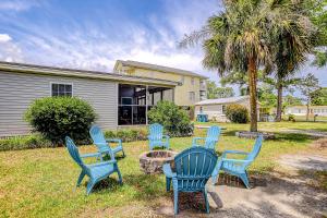 a group of blue chairs sitting in a yard at Pura Vida - 2 Houses - Murrells Inlet in Myrtle Beach