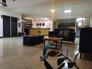 a living room with couches and a table in a room at Mándala Hotel Belén in Medellín