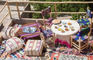 a table and two chairs and a table with plates of food at Toubkal Views in Imlil