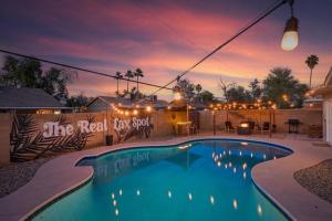 a swimming pool in a yard with a sunset in the background at Tempe ASU, Summer Spot with Heated Pool, Gameroom in Tempe