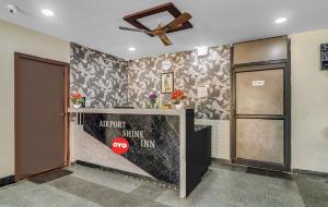 a elevator entrance with a ceiling fan and a door at Hotel Airport Shine Inn in Shamshabad