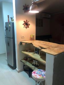 a kitchen with a wooden counter and a refrigerator at Apto en Flandes Palma real in Flandes