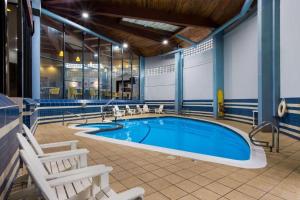 a large swimming pool with chairs around it at Best Western Bordentown Inn in Bordentown