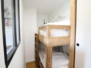 a wooden bunk bed in a room with a mirror at Appartement Les Gets, 2 pièces, 4 personnes - FR-1-623-304 in Les Gets