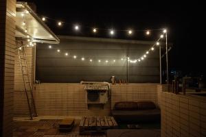 a group of lights on a patio at night at Bare Foot Diving Hostel 2 in Hengchun