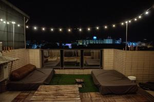 a rooftop patio at night with lights at Bare Foot Diving Hostel 2 in Hengchun