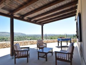 a patio with chairs and a table and a view at Holiday Home Floridia with Private Pool in Floridia