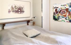 a white bed with a pillow on top of it at Pet Friendly Home In Gvle With Wifi in Gävle