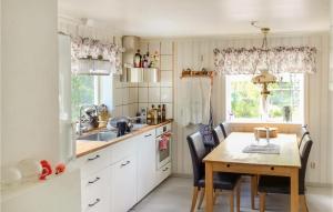 a kitchen with a wooden table and a table and chairs at Pet Friendly Home In Gvle With Wifi in Gävle