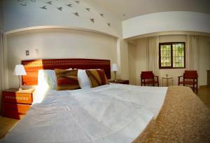 a bedroom with a large white bed in a room at Inkantari Boutique Hotel in Cusco