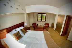 a bedroom with a large bed with birds on the wall at Inkantari Boutique Hotel in Cusco +51 photos