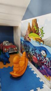 a childs room with a ocean themed wall at Casa Espaço Pérola in Rio das Ostras