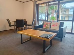 salon z kanapą i stolikiem kawowym w obiekcie Half Moon Bay Motel w Auckland
