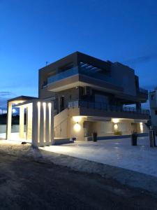 a large building with a lit up facade at night at Stbs Luxury, Nea Fokea in Nea Fokea