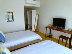 Postel nebo postele na pokoji v ubytování Nakijin Resort Guest House