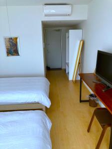 Postel nebo postele na pokoji v ubytování Nakijin Resort Guest House