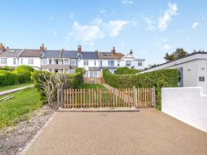 a house with a wooden gate and a fence at Happy House in Bevendean