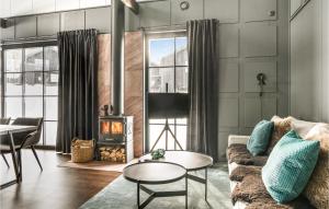 a living room with a couch and a fireplace at Amazing Home In Slen With Wifi in Stöten