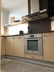 a kitchen with a stainless steel oven and cabinets at LuxAppart-Paris in Paris