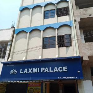 a building with a blue sign on the front of it at OYO Flagship 81322 Laxmi Palace in Rourkela