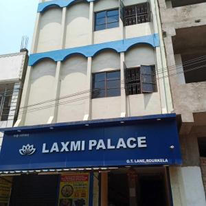 a building with a blue sign in front of it at OYO Flagship 81322 Laxmi Palace in Rourkela