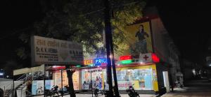 a group of shops on a city street at night at SPOT ON 81358 Sun Shine Hotel in Jabalpur