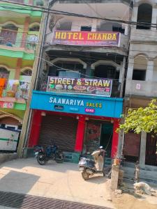 a hotel pharmacy with a motorcycle parked in front of it at OYO 81285 Hotel Chanda in Madhubani