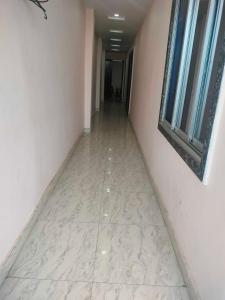 a hallway with a tile floor in a building at OYO 81285 Hotel Chanda in Madhubani