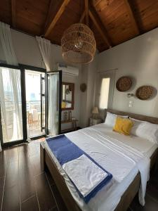 a bedroom with a large bed and a large window at Sunset in Megalochori