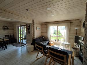a living room with a couch and a table at GREY PINE HOUSE in Druskininkai