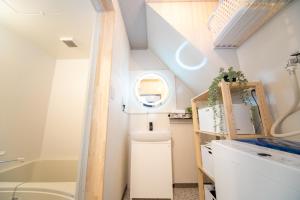 a small bathroom with a toilet and a sink at Yokkaichi Kawaramachi Hotel in Hazu +34 photos