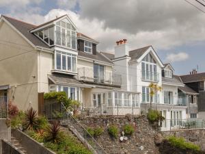 a large white house with a stone wall at Seascape in Salcombe