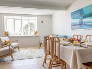 a dining room with a table and chairs at Seascape in Salcombe