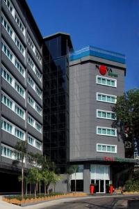 a large building with a vanguard at Nova Express Pattaya Hotel in Pattaya Central