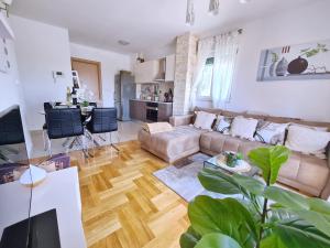 a living room with a couch and a table at Luxury apartment Salona in Solin