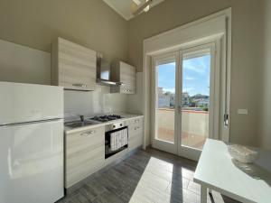 a kitchen with a refrigerator and a stove top oven at Affittacamere Villa Paestum in Paestum