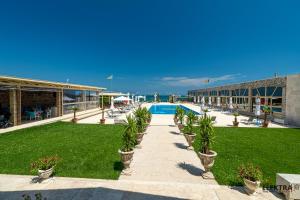 a resort with a swimming pool and a building at Elektra Vama Veche in Vama Veche