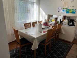 a kitchen with a table with chairs and a kitchenestamp at 2 Bedroom's 1 sitting room Majesty Palace in Espoo