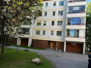 an apartment building with a parking lot in front of it at 2 Bedroom's 1 sitting room Majesty Palace in Espoo