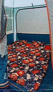 a bed in the back of a tent at Zions Camping sight in Srinagar