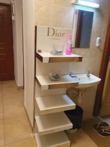 a bathroom with a sink and a mirror and a sink at Airview Apartments in Nairobi +4 photos