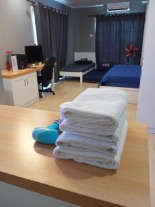 a pile of towels sitting on the floor of a room at Kampar Champs Elysees, King Bed Studio unit 12A21 in Kampar