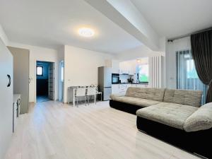 a large living room with a couch and a table at Altheda Living Zamca C4 in Suceava