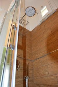 a bathroom with a shower with a wooden floor at Casa Magistrale in Trapani