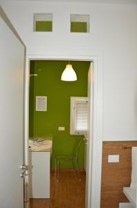 a green room with a table and a chair at Casa Magistrale in Trapani