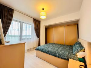 a hotel room with a bed and a window at Altheda Living Zamca C4 in Suceava
