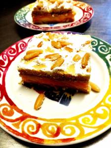 a plate with a piece of cake on a table at B&B da AnnaMaria in Chiessi