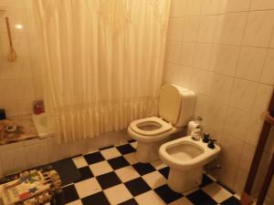 y baño con aseo y lavamanos. en Casa rústica en Santiago del Estero